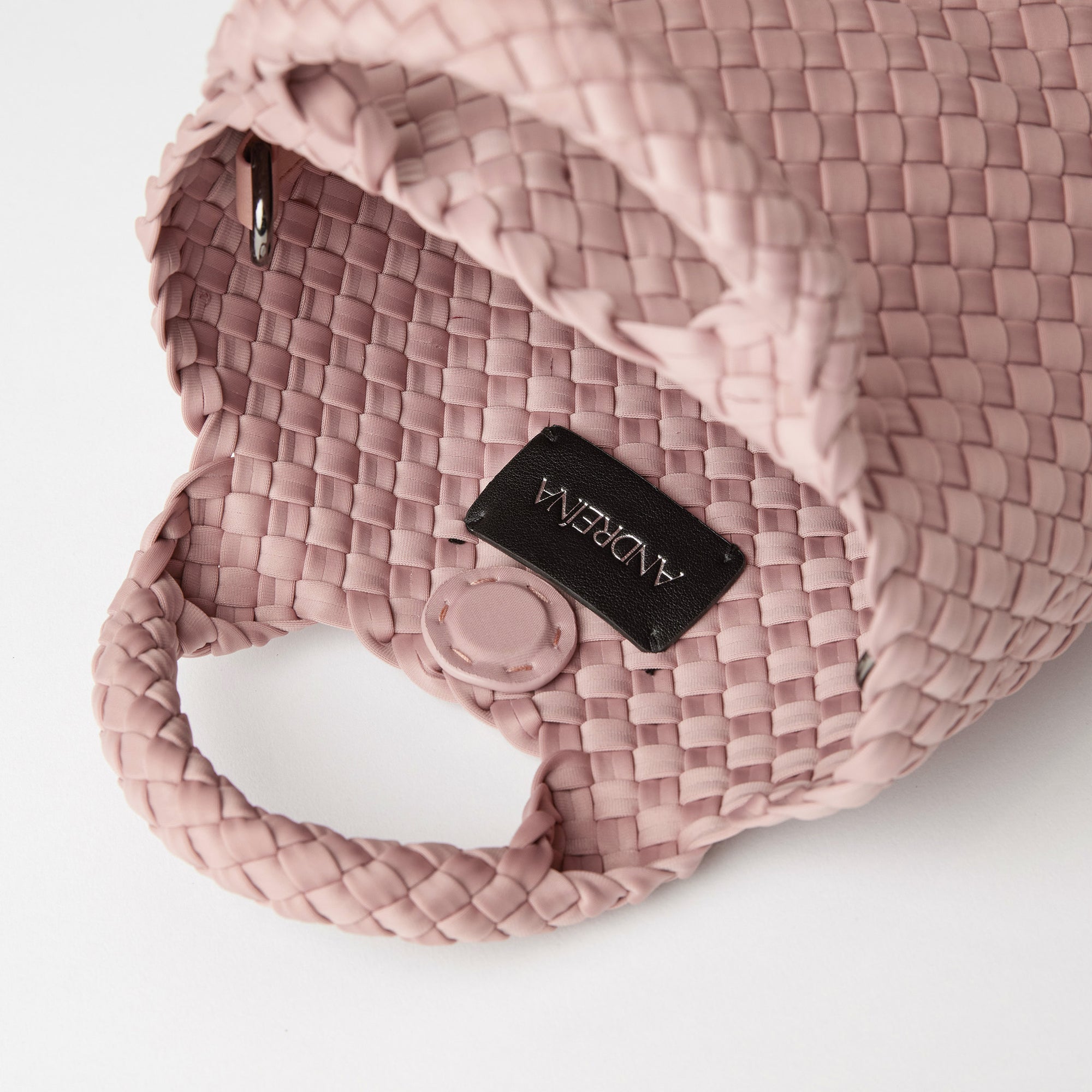 Andreina Bags Lupe crossbody bag in dusty rose colour. small size yet roomy. Handmade, interlaced material, synthetic material, water resistant, machine washable, adjustable strap, lightweight. Can be worn as crossbody or as a handbag. Designed in Sydney, Australia.