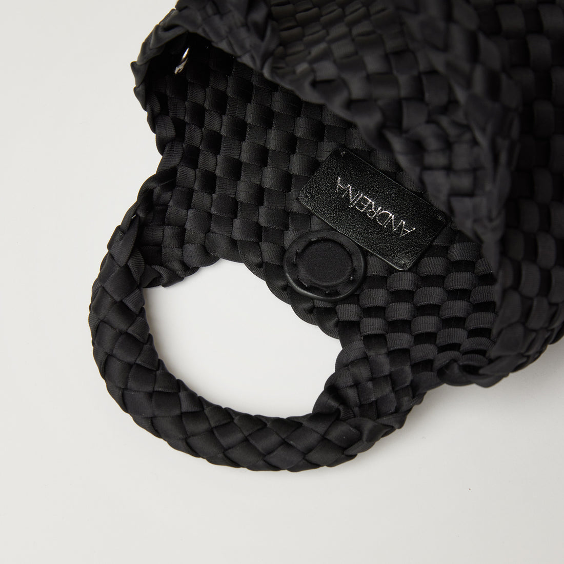 Andreina Bags Lupe crossbody bag in black colour. small size yet roomy. Handmade, interlaced material, synthetic material, water resistant, machine washable, adjustable strap, lightweight. Can be worn as crossbody or as a handbag. Designed in Sydney, Australia.