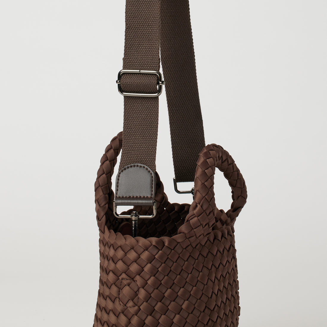 Andreina Bags Lupe crossbody bag in brown colour. small size yet roomy. Handmade, interlaced material, synthetic material, water resistant, machine washable, adjustable strap, lightweight. Can be worn as crossbody or as a handbag. Designed in Sydney, Australia.