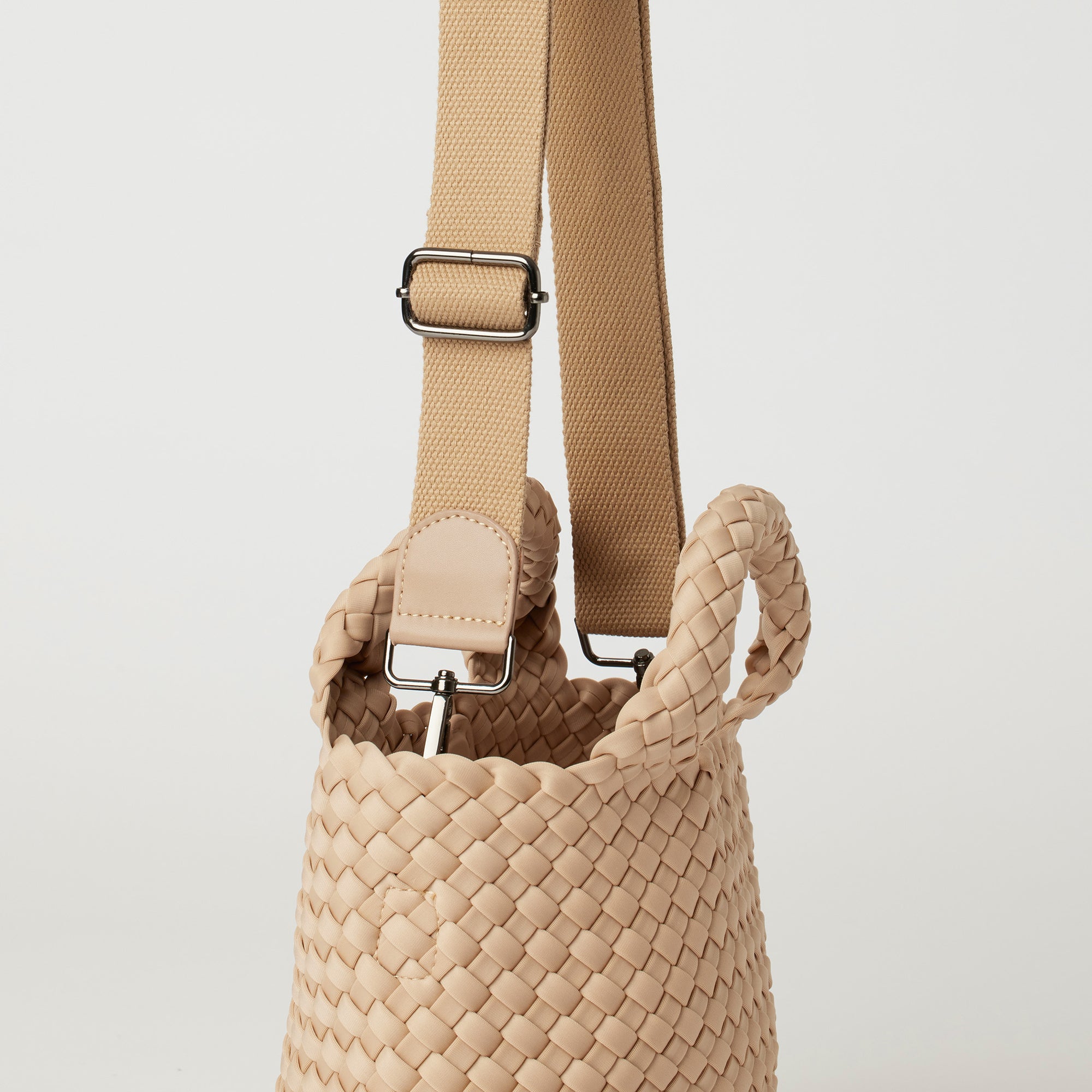 Andreina Bags Lupe crossbody bag in cream colour. small size yet roomy. Handmade, interlaced material, synthetic material, water resistant, machine washable, adjustable strap, lightweight. Can be worn as crossbody or as a handbag. Designed in Sydney, Australia.