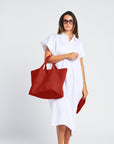 woman in a summer white dress with a tote made of neoprene