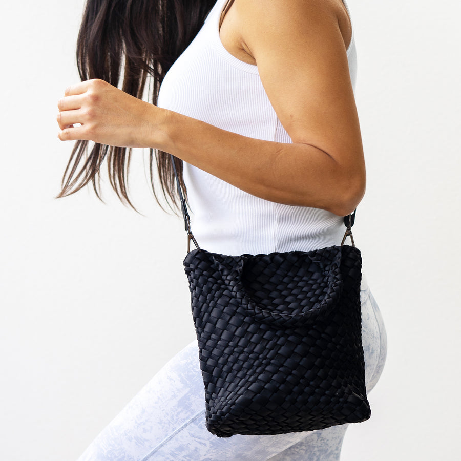 woman wearing a small black Andreina Bags crossbody bag 